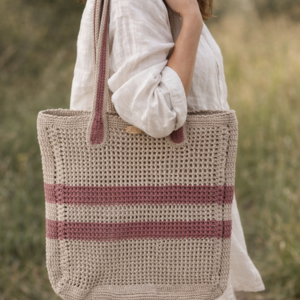 Handgefertigter Shopper „Zwei Streifen“ aus Häkelarbeit mit zwei Streifen, über der Schulter getragen im natürlichen Outdoor-Umfeld